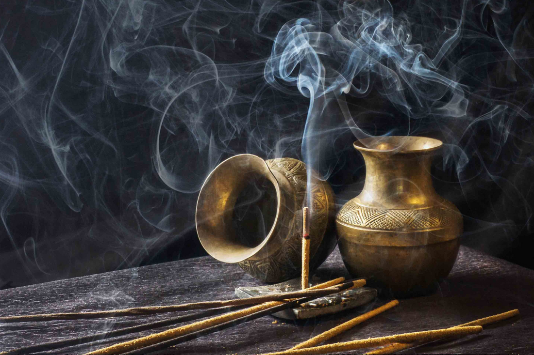 Incense smoke rising gently from a wooden holder, surrounded by Norse runes and candles, representing mindfulness and sacred Norse rituals.
