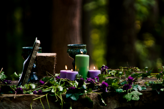 Forest altar adorned with candles, herbs, and ritual tools, symbolizing a Norse-inspired sacred space for meditation and spiritual practice.